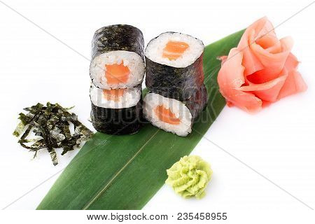 Delicious Fresh Mini-rolls With Salmon On A Banana Leaf. Sushi Rolls On A White Background With Ging