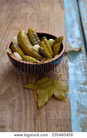Marinaded Cucnbers In Ceramic Dish On Board.