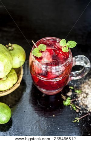 Close Up Of Popular Indian Shrabat Of Guava With Sugar And Masala In A Glass With Raw Fresh Guava On