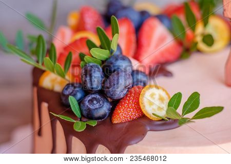 Beautiful Homemade Cake With Cream Cheese Frosting , Strawberries And Blueberries On A Wooden Table