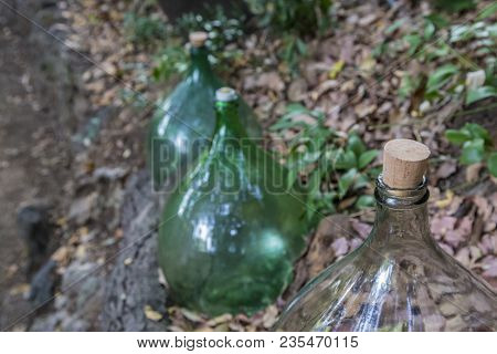 Closeup Of Glass Carboy With Cork With Background