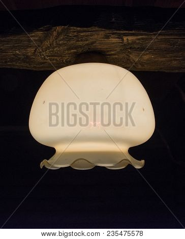 Close-up Of A Plafond Of A Burning Lamp On A Dark Background