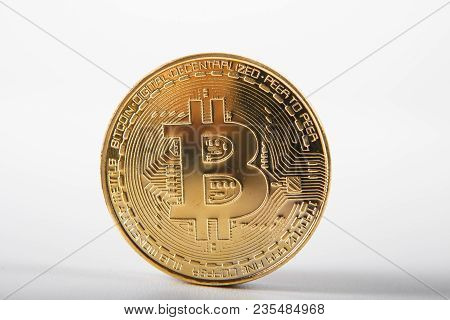 Golden Bitcoin On Isolated On White Table. A Visual Representation Of Digital Cryptocurrencies. Bitc