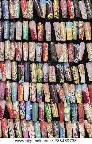 Set With Different Patterns On The Nails On Palette In Cosmetic Store.