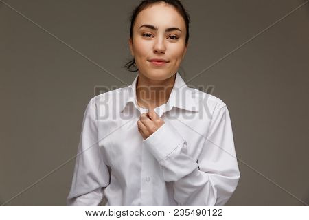 Beautiful Girl In A White Shirt Shows Emotions. On A Light Background.