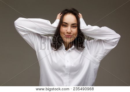 Beautiful Girl In A White Shirt Shows Emotions. On A Light Background.