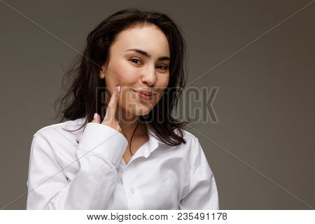 Beautiful Girl In A White Shirt Shows Emotions - Smile, Fun. On A Light Background.