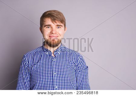Portrait Of A Handsome Young Man Smiling Against Blue Background