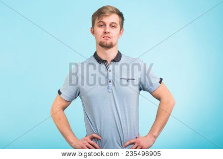 Portrait Of A Handsome Young Man Smiling Against Blue Background
