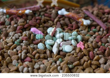 Vitamin Tablets For Pets On Hip Of Dry Pet Food
