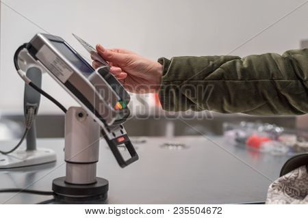 Women's Hand Pays For Purchases In The Store Card Contactless Way, Wireless Technology, Paypass