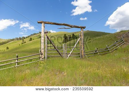 Lush, Green Landscape With Wooden Fence And Entry Gate In Remote Area Of Highwood, Montana, Usa.