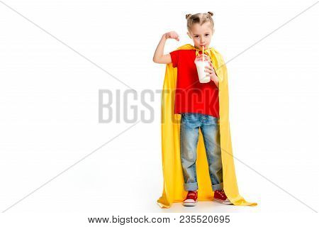 Supergirl In Yellow Cape Drinking Milkshake And Showing Muscles On Hand Isolated On White