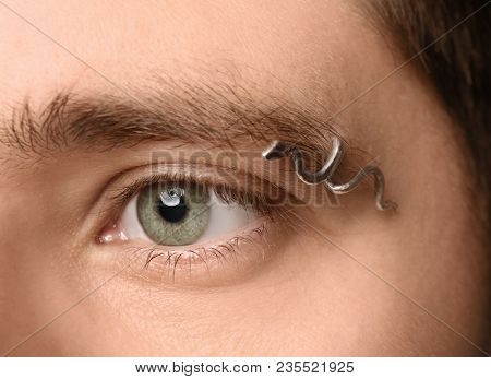 Young man with pierced eyebrow, closeup