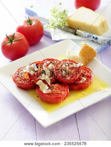 Baked Tomatoes With Olive Dressing Sprinkled With Grated Parmesan And Served With Bread