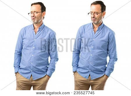Middle age handsome man making funny face fooling over white background