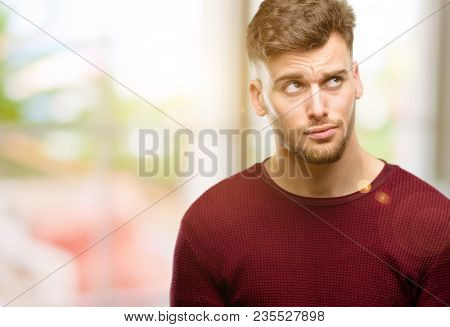 Handsome young man making funny face fooling