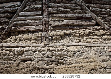 Stone Wall With Stone, Wood And Mud Background
Rustic Wall In A Old Construction With Stone, Wood An