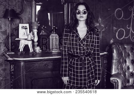 Beautiful Elegant Woman Dressed In A Blue Checkered Suit In Red Interior