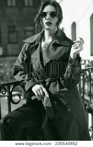 Beautiful Elegant Brunette Woman Wearing Green Coat On The Balcony
