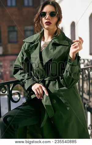 Beautiful Elegant Brunette Woman Wearing Green Coat On The Balcony