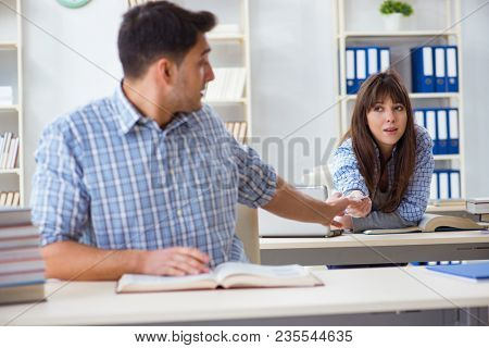 Students sitting and studying in classroom college
