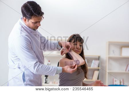 Doctor checking patients joint flexibility