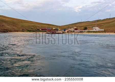 Ferry Dock On The Island Of Olkhon. Lake Baikal. Cars Are Waiting On The Shore For Their Turn To Cro