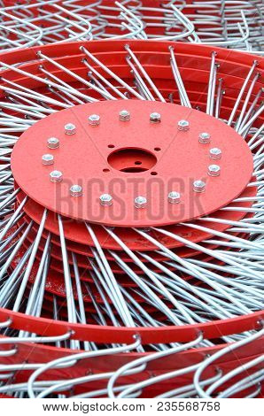 New Red Tedder For Trailer In Agricultural Machinery For Gathering Hay. Close Up
