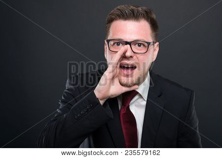 Business Man Wearing Black Suit Screaming Out Loud.