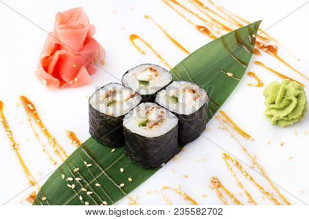 Delicious Fresh Mini-rolls With Cucumber, Eel And Cheese On A Banana Leaf. Sushi Rolls On A White Ba