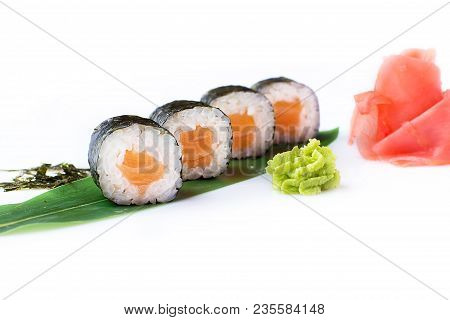 Delicious Fresh Mini-rolls With Salmon On A Banana Leaf. Sushi Rolls On A White Background With Ging