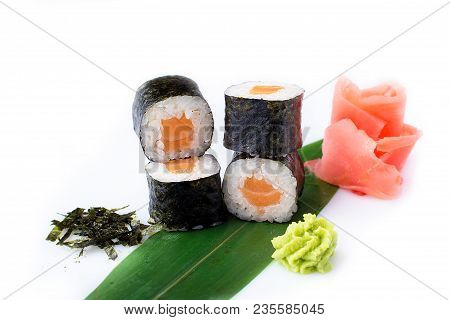 Delicious Fresh Mini-rolls With Salmon On A Banana Leaf. Sushi Rolls On A White Background With Ging