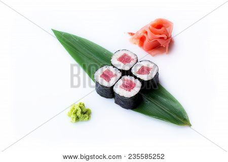 Delicious Fresh Mini-rolls With Tuna On A Banana Leaf. Sushi Rolls On A White Background With Ginger