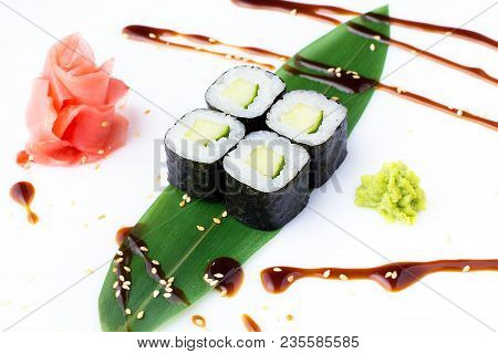Delicious Fresh Mini-rolls With Cucumber On A Banana Leaf. Sushi Rolls On A White Background With Gi