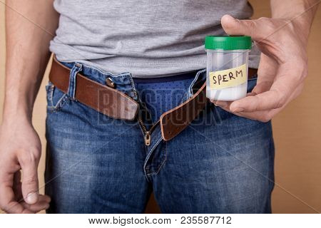 Sample Of Sperm For Analysis Of Infertility. Man Is Holding A Jar Of Tests In His Hands. Concept Of 