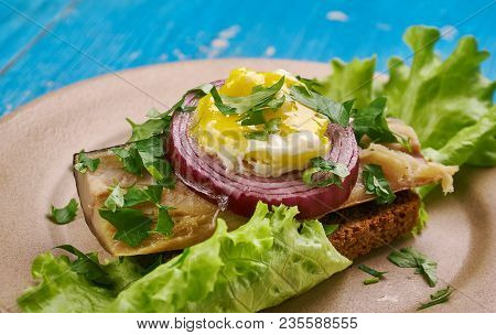 Sol Over Gudhjem - Danish Dish, An Open Sandwich With Rugbrod, Smoked Herring, Chives And A Raw Egg 