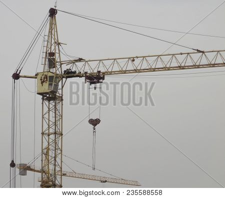 Construction Cranes Against The Gray Sky. Industrial Constrcution Cranes. Abstract Background With C