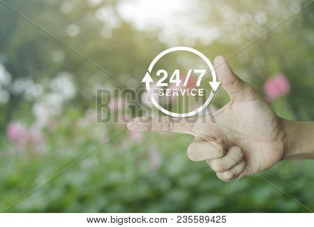 24 Hours Service Icon On Finger Over Blur Pink Flower And Tree, Full Time Service Concept