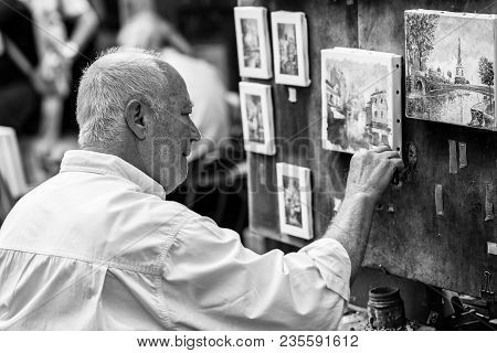 Paris, France - July 06, 2017: The Painter Works At The Open Air Artist Market At The Tertre Square 