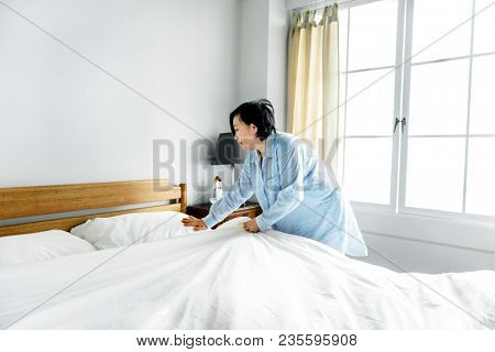 A woman making bed