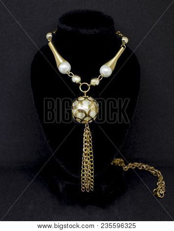 Gold Pearl Round Surreal Necklace With Chain On Black Background