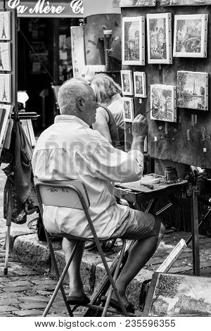 Paris, France - July 06, 2017: The Painter Works At The Open Air Artist Market At The Tertre Square 