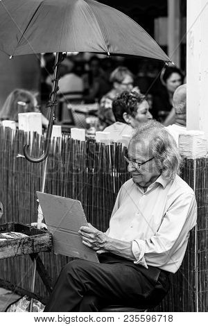 Paris, France - July 06, 2017: The Painter Works At The Open Air Artist Market At The Tertre Square 