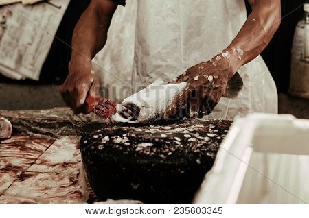 Fresh Market Scene In Malaysia, Fish Monger Clening His Fish Before Selling Activity.image May Conta