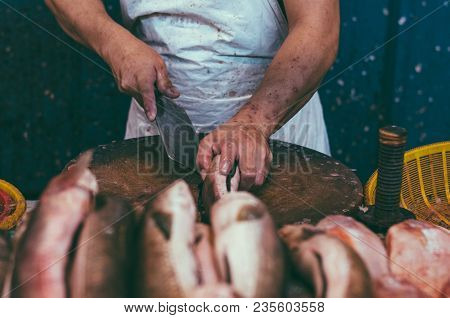 Fresh Market Scene In Malaysia, Fish Monger Clening His Fish Before Selling Activity