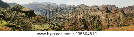Gorgeous Panorama View Of Huge Barren Mountain Peaks, Cliff And Canyons Of Dry Arid Desert Landscape