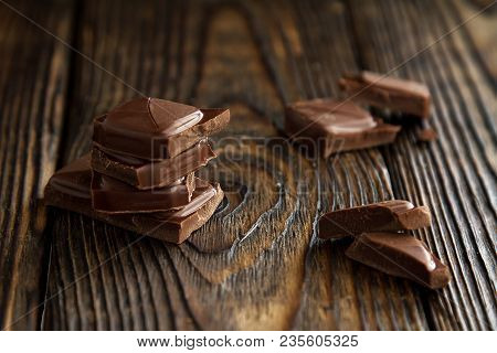 A Block From Delicious Dark Chocolate Bar Pieces On A Wooden Dark Old Table In Style Moodle