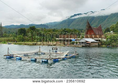 Traditional Fish Cage On Danau Toba Lake, Medan, Indonesia With Moutain Background Covered With Clou