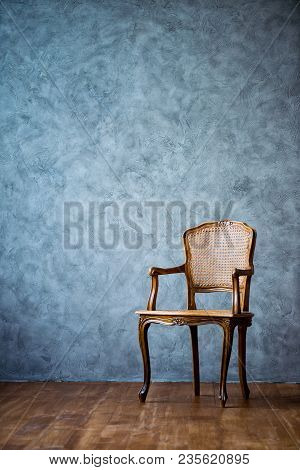 Old Chair On A Gray Wall Background